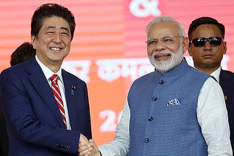 Japanese Prime Minister Shinzo Abe (L) shakes hands with his Indian counterpart Narendra Modi