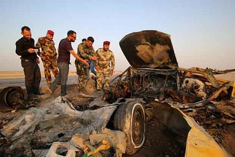 Iraqi security forces inspect the site of a bomb attack at a police checkpoint .(Photo: Reuters)