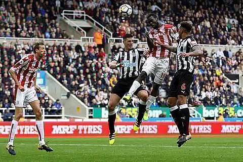 Stoke City's Biram Diouf in action with Newcastle United's Jamaal Lascelles (R) and Ciaran Clark