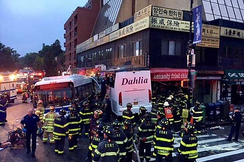 A New York City transit bus and a Dahlia tour bus collided before slamming into a building, New York
