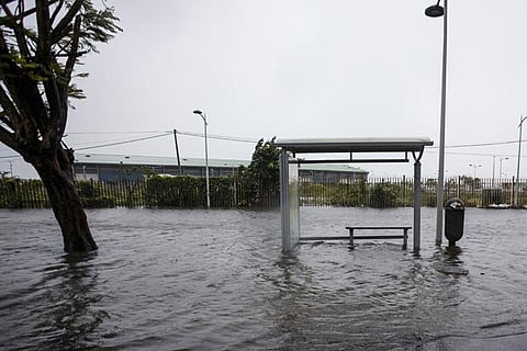 A flooded road and a bus stop are pictured on Boulevard Chanzy in downtown Pointe-a-Pitre