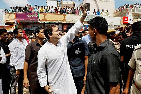 Congress vice-president Rahul Gandhi waves at supporters during his road show