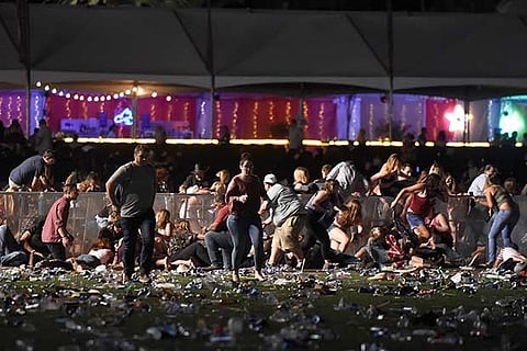 People run from the Route 91 Harvest country music festival