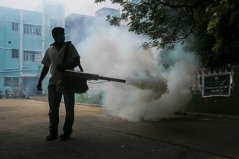 A corporation worker sprays insecticide at the Government Hospital in Chennai