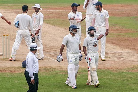 Tripura?s Smit Patel and Yashpal walk back after a session in Chennai on Saturday