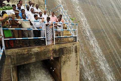 Deputy Chief Minister O Panneerselvam offers flowers when the water from Sothuparai dam was released