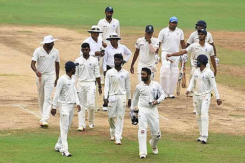 Tamil Nadu players leave the field after the match ended in a draw in Chennai on Tuesday