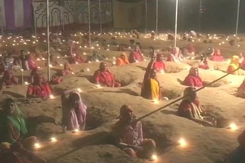 Women protest by staying neck deep in pits against acquisition of lands on Diwali (Source: ANI)