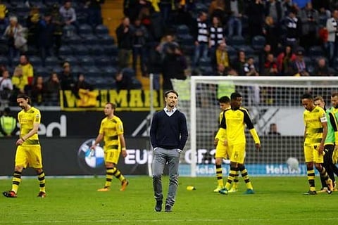 Frankfurt coach Niko Kovac looks on as the Borussia Dortmund players look dejected