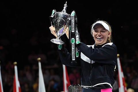 Caroline Wozniacki holds the trophy after an emphatic win