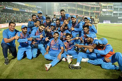 Ashish Nehra with his teammates pose for a photo after the first T20 match win against NZ