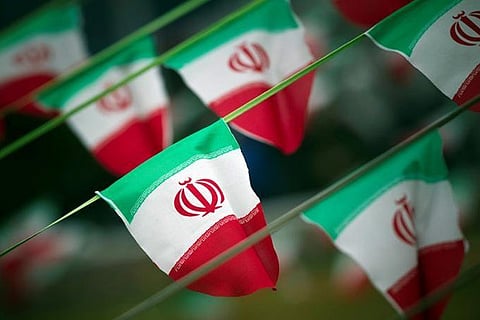 Iran's national flags are seen on a square in Tehran