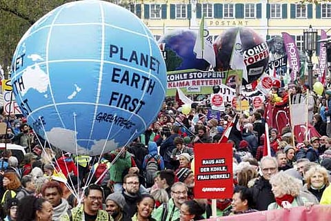 Protestors demand the implementation of the climate change convention in Bonn