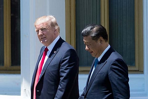 File photo of US President Donald Trump (L) and Chinese President Xi Jinping (R)
