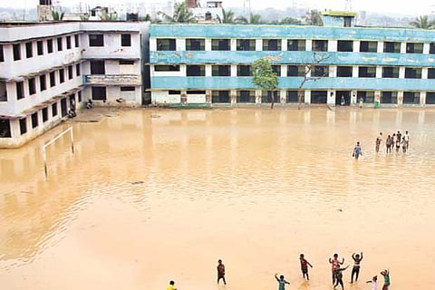 Children play in stagnant rainwater at Government Higher Secondary School compound , Vyasarpadi