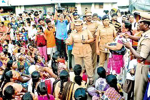 Police pacifying the Thideer Nagar residents, who staged a road blockade