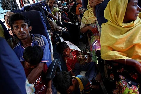 Newly arrived Rohingya refugees are bused to a registration point at an army centre