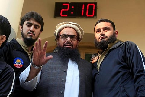Hafiz Saeed speaks with supporters after attending Friday Prayers in Lahore, Pakistan