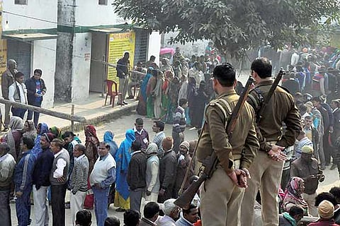 People wait in queues to cast their votes for civic polls in Moradabad