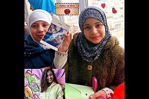 Refugee children show postcards of letters from other children. Inset: Pooja Pradeep