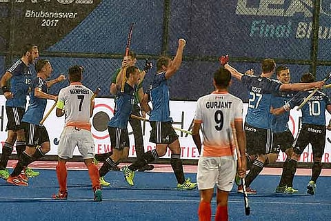 Argentina players celebrate after scoring a goal against India