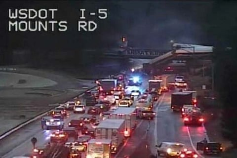 An Amtrak passenger train is seen derailed on a bridge over interstate highway I-5.(Photo: Reuters)