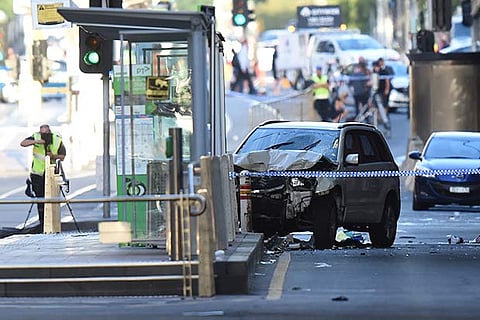 A white SUV (C) sits in the middle of the road