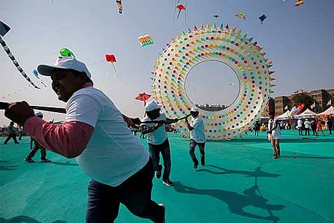 Kite-flying enthusiasts try to fly a ring kite on the first day of the eight-day-long International