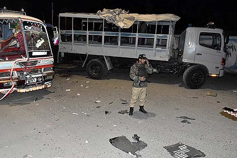 A soldier stands at the scene off a blast targeting a police truck in Quetta, Pakistan