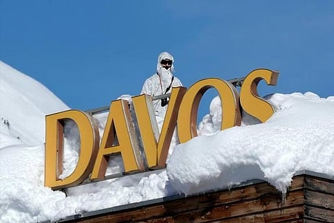 Swiss special police observes the surrounding area from atop the roof of the Davos Congress Hotel