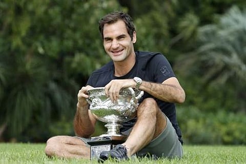 Roger Federer of Switzerland poses with the men's singles cup of the Australian Open