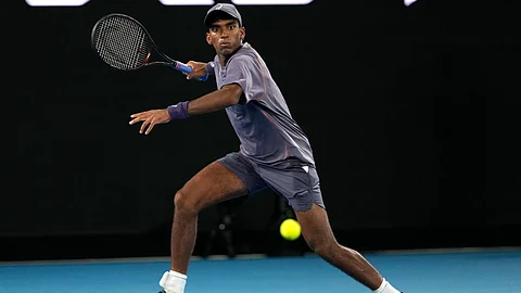 Nishesh Basavareddy plays a forehand return to Novak Djokovic of Serbia during their first round match at the Australian Open tennis championship in Melbourne, Australia, Monday, January 13, 2025.