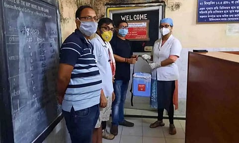 The social workers handing over the plasma box