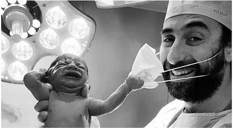 Viral pic of baby removing doctor's mask becomes glimpse of hope amid the pandemic