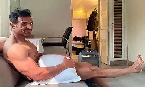 John Abraham is 'waiting for wardrobe', poses with just a pillow!