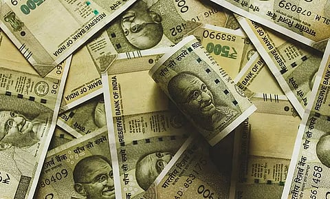 Rupee slips on RBI's dovish stance, loose policy