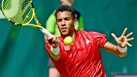 Auger-Aliassime rallies to beat Federer