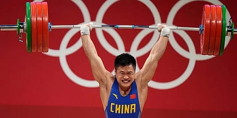 Chinese veteran Lyu Xiaojun becomes oldest weightlifter at 37 to win Olympic gold