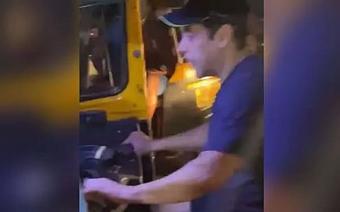 Salman Khan drives an auto-rickshaw on a busy street