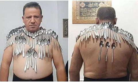 Iranian Man Breaks World Record, Balances 85 Spoons On His Body