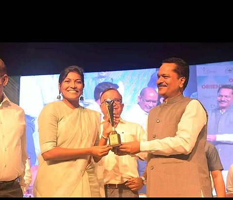 Guardian Minister Ashok Singhal hands over award to Cachar DC Keerthi Jalli