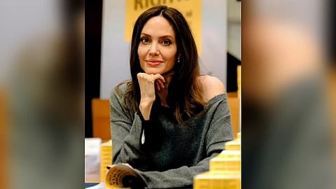 Actress Angelina Jolie does Electric Slide at daughter's college send-off