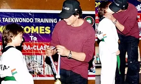 Bollywood superstar Shah Rukh Khan kisses son AbRam, honours him with gold medal