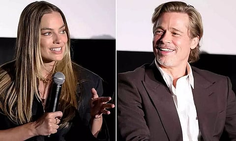 Australian actress and producer Margot Robbie says she shocked Brad Pitt with her improvised kiss