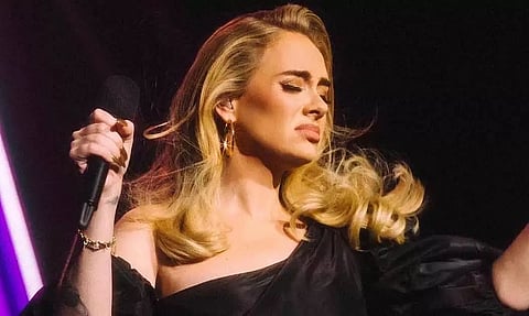 English singer Adele tears up seeing man holding picture of his late wife at her concert