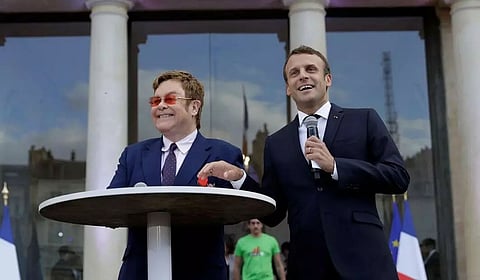President Emmanuel Macron parties with singer Elton John
