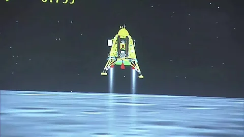 Indian Space Research Organization officials over the moon as lander touches lunar surface