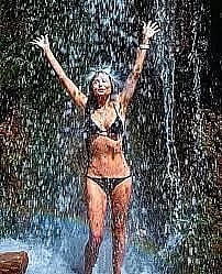 Demi Moore sizzles in black bikini under a waterfall
