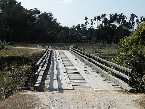 Snail pace of construction work of wooden bridge over Kherkotia river irks Lakhimpur people