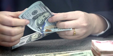 US dollar edges up amid economic data